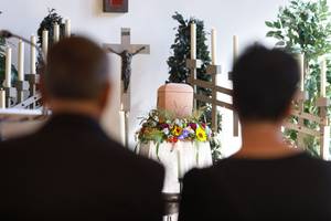 Eine Bestattungsfeier mit einer Urne.